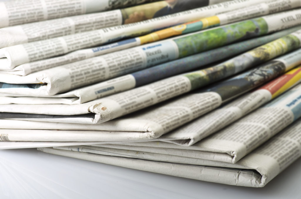 Media coverage for your small business, charity, or not-for-profit; or will it be for your competitors? Pile of newspapers used in blog post by Pure Public Relations, a boutique PR agency in Sydney and Melbourne.