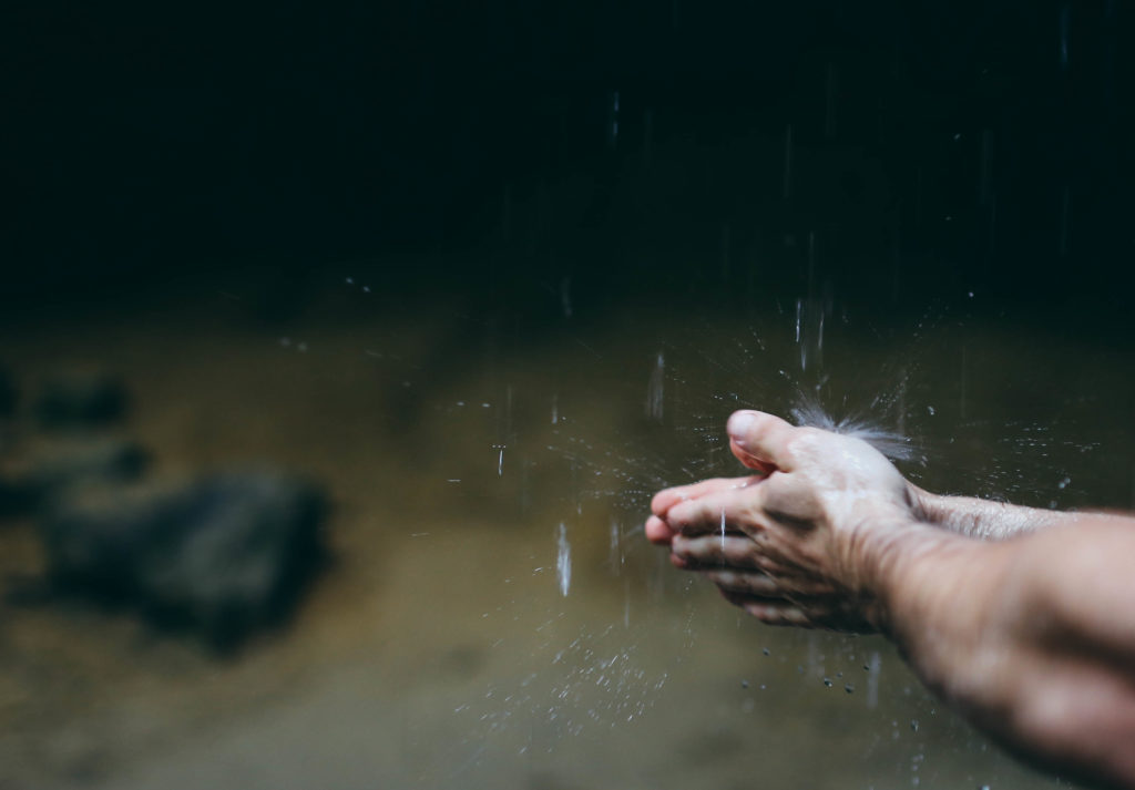 This is a photo of a pair of hands washing under falling rain used for the article titled 'The cost of business integrity is priceless' written by Phoebe Netto, PR Consultant from Sydney.